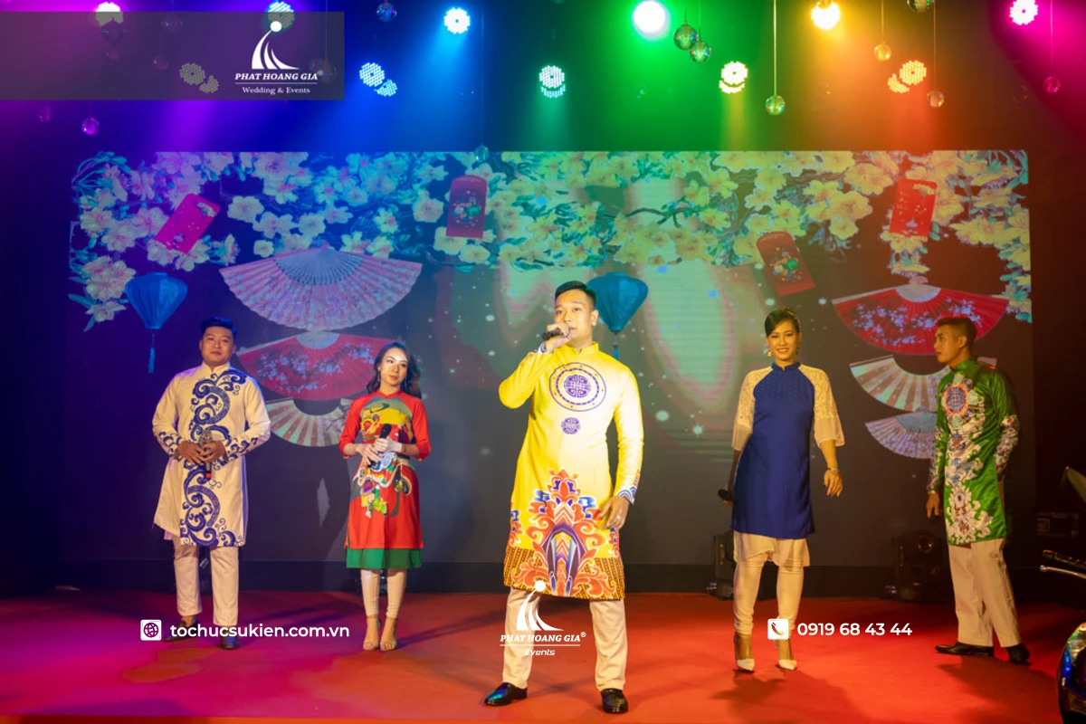 Các thành viên cùng hòa giọng  dưới ánh đèn đa sắc màu của tiết mục văn nghệ cuối năm