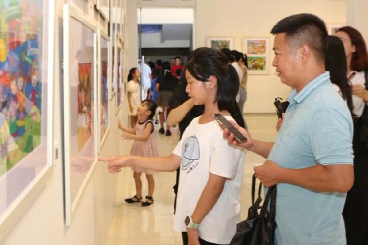 Phụ huynh và các em nhỏ cùng nhau tham quan triển lãm tranh nghệ thuật dịp tổ chức quốc tế thiếu nhi